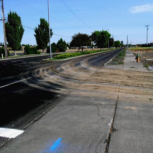 Soil tracked out from a construction site onto a roadway.